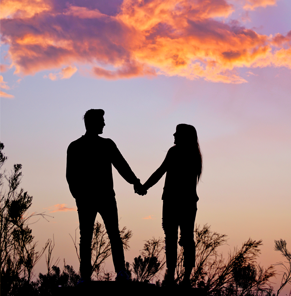 couple holding hands beautiful sunset